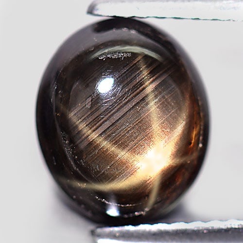 Natural Black Star Sapphire 6 Rays 4.76 Ct. Oval Cabochon Shape 10 x 8.5 Mm. Gemstone From Thailand: Product ID: 806136058 Product Name: Natural Star Sapphire Weight: 4.76 CT. Size: 10 x 8.5 x 4.6 MM. Shape: Oval Cabochon Color: Black Clarity:Opaque Luster: Good 6 Rays Star Gems Origin: Thailand Trea