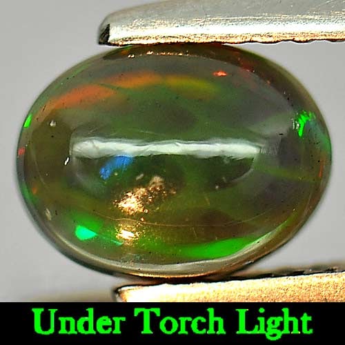Natural Fire Red Black Opal 0.88 Ct. Oval Cabochon Shape 8.1 x 6.2 Mm Gemstone From Ethiopia: Product ID: 818724302 Product Name: Natural Opal Weight: 0.88 CT. Size: 8.1 x 6.2 x 3.5 MM. Shape: Oval Cabochon Color: Rainbow Fire Red Black Clarity:Semi - Transparent Luster: Iridescent Gems Origin