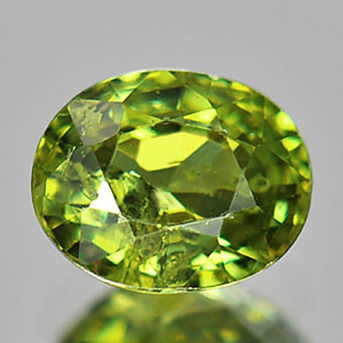 Natural Green Demantoid Garnet 1.01 Ct. Oval Shape 6.5 x 5.2 Mm. Gemstone From Madagascar: Product ID: 802924291 Product Name: Natural Demantoid Weight: 1.01 CT. Size: 6.5 x 5.2 x 3.3 MM. Shape: Oval Color: Green Clarity:SI Luster: Good Gems Origin: Mardagascar Treatment: Unheated Crystal S