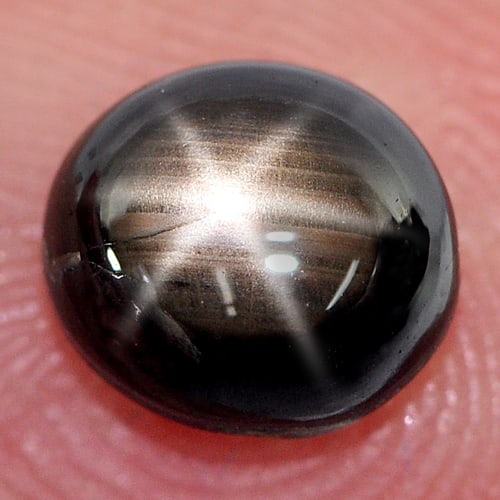 Natural Black Star Sapphire 6 Rays 2.01 Ct. Oval Cabochon Shape 7 x 6.2 Mm Gemstone From Thailand: Product ID: 806127439 Product Name: Natural Star Sapphire Weight: 2.01 CT. Size: 7 x 6.2 x 4 MM. Shape: Oval Cabochon Color: Black Clarity:Opaque Luster: Good Gems Origin: Thailand Treatment: Heated C