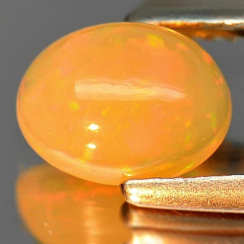 Natural Multi Color Play Of Colour Opal 0.92 Ct. Oval Cabochon Shape 8 x 6.2 Mm Gemstone From: Product ID: 818726261 Product Name: Natural Opal Weight: 0.92 CT. Size: 8 x 6.2 x 3.8 MM. Shape: Oval Cabochon Color: Multi Color Clarity:Semi - Transparent Luster: Iridescent Gems Origin: Ethiopia Tr