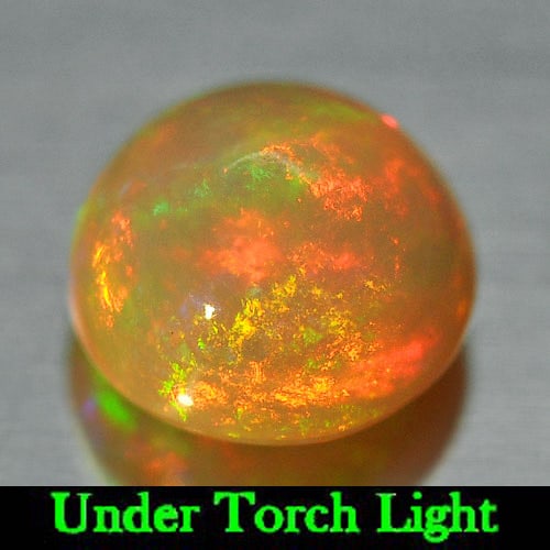 Natural Multi Color Play Of Colour Opal 1.04 Ct. Round Cabochon Shape 6.9 Mm Gemstone From Ethiopia: Product ID: 818725241 Product Name: Natural Opal Weight: 1.04 CT. Size: 6.9 x 6.9 x 4.8 MM. Shape: Round Cabochon Color: Multi Color Clarity:Semi - Transparent Luster: Iridescent Gems Origin: Ethiopia