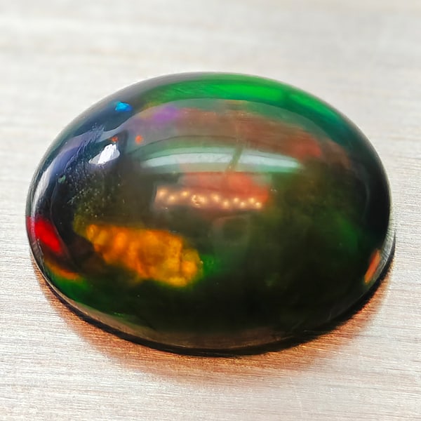 Natural Multi-Color Play Of Colour Opal 1.14 Ct. Oval Cabochon Shape 9 x 7 Mm Gemstone From Ethiopia: Product ID: 818728021 Product Name: Natural Opal Weight: 1.14 CT. Size: 9 x 7 x 3.8 MM. Shape: Oval Cabochon Color: Multi-Color Clarity:Semi - Transparent Luster: Iridescent Gems Origin: Ethiopia Trea