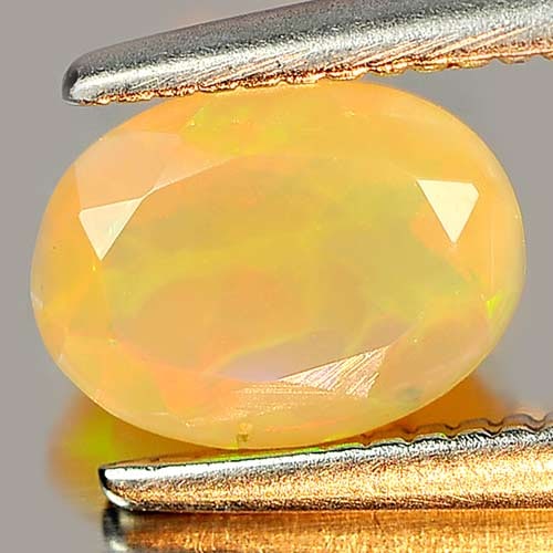 Multi Color Play Of Colour Opal 0.54 Ct. Oval Shape 7 x 5.5 Mm. Natural Gemstone Unheated From: Product ID: 818726032 Product Name: Natural Opal Weight: 0.54 CT. Size: 7 x 5.2 x 3.4 MM. Shape: Oval Color: Multi Color Clarity:Semi - Transparent Luster: Strong Iridescent Gems Origin: Ethiopia Trea