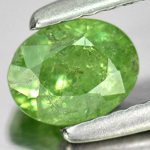 Natural Green Demantoid Garnet 0.79 Ct. Oval Shape 5.9 x 4.5 Mm. Gemstone From Madagascar: Product ID: 802919240 Product Name: Natural Demantoid Weight: 0.79 CT. Size: 5.9 x 4.5 x 3.5 MM. Shape: Oval Color: Green Clarity:SI Luster: Good Gems Origin: Madagascar , Africa Treatment: Unheated C