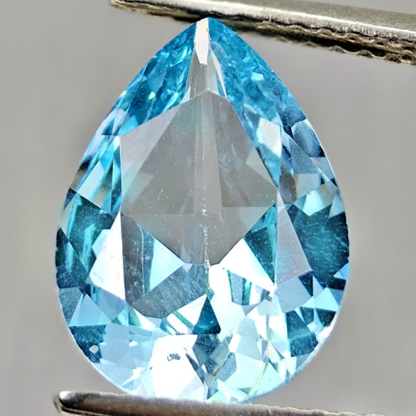 Natural Swiss Blue Topaz 3.28 Ct. Pear Shape 12.4 x 8.9 Mm Gemstone From Brazil: Product ID: 807167901 Product Name: Natural Blue Topaz Weight: 3.28 CT. Size: 12.4 x 8.9 x 4.6 MM. Shape: Pear Shape Color: Swiss Blue Clarity:VSI Luster: Good Gems Origin: Brazil Treatment: Treated C