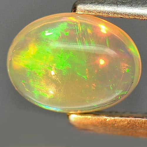 Natural Multi Color Play Of Colour Opal 0.92 Ct. Oval Cabochon Shape 8 x 6 Mm. Gemstone From: Product ID: 818726259 Product Name: Natural Opal Weight: 0.92 CT. Size: 8 x 6 x 3.8 MM. Shape: Oval Cabochon Color: Multi Color Clarity:Semi - Transparent Luster: Iridescent Gems Origin: Ethiopia Trea