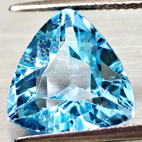 Natural Swiss Blue Topaz 6.92 Ct. Trilliant Shape 12.10 Mm Gemstone From Brazil: Product ID: 807167931 Product Name: Natural Blue Topaz Weight: 6.92 CT. Size: 12.1 x 12.1 x 7 MM. Shape: Trilliant Color: Swiss Blue Clarity:VSI Luster: Good Gems Origin: Brazil Treatment: Treated Cry