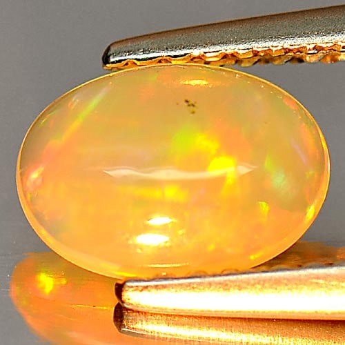 Natural Multi Color Opal 0.58 Ct. Oval Cabochon Shape 8.1 x 5.8 Mm. Uneheated Gemstone: Product ID: 818726248 Product Name: Natural Opal Weight: 0.58 CT. Size: 8.1 x 5.8 x 2.7 MM. Shape: Oval Cabochon Color: Multi Color Clarity:Semi - Transparent Luster: Iridescent Gems Origin: Ethiopia 