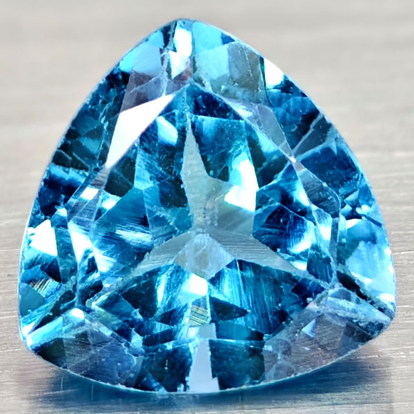 Natural Swiss Blue Topaz 3.28 Ct. Trilliant Shape 8.9 Mm Gemstones From Brazil: Product ID: 807167961 Product Name: Natural Blue Topaz Weight: 3.28 CT. Size: 8.9 x 8.9 x 6.1 MM. Shape: Trilliant Color: Swiss Blue Clarity:VSI Luster: Good Gems Origin: Brazil Treatment: Treated Cry
