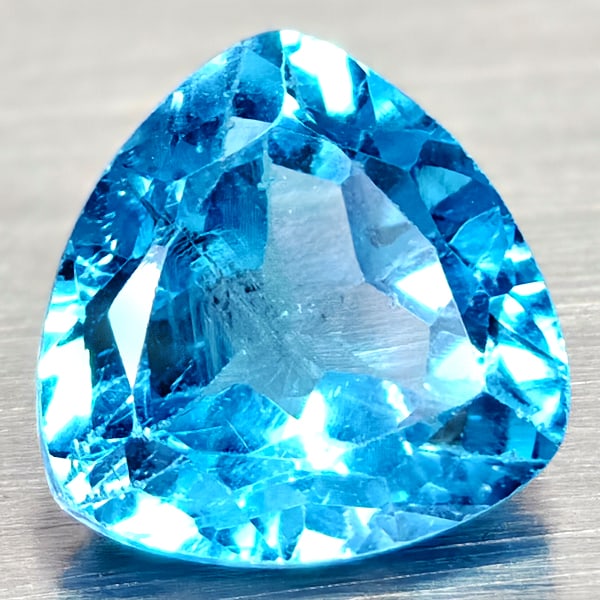 Natural Swiss Blue Topaz 3.81 Ct. Trilliant Shape 9.2 Mm Gemstones From Brazil: Product ID: 807167960 Product Name: Natural Blue Topaz Weight: 3.81 CT. Size: 9.2 x 9.2 x 5.8 MM. Shape: Trilliant Color: Swiss Blue Clarity:VSI Luster: Good Gems Origin: Brazil Treatment: Treated Cry