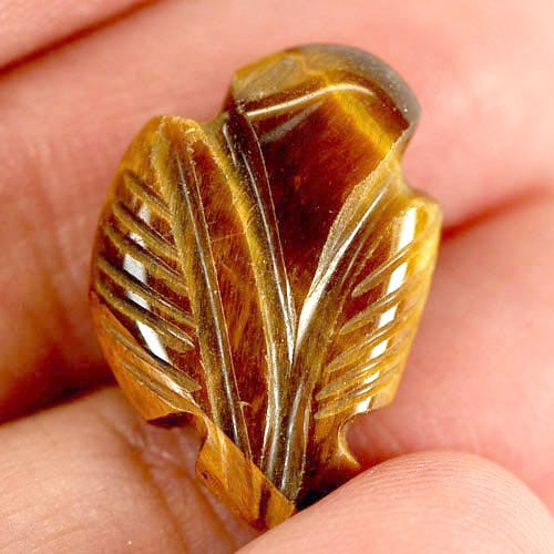 Natural Tiger Eye Golden 8.63 Ct. Leaves Carving 19 x 13 Mm. Gemstone Unheated: Product ID: 811600020 Product Name: Natural Tiger eye Weight: 8.63 CT. Size: 19 x 13 x 4.9 MM. Shape: Carving Leaves Color: Golden Clarity:Opaque Luster: Good Gems Origin: Thailand Treatment: Unheated