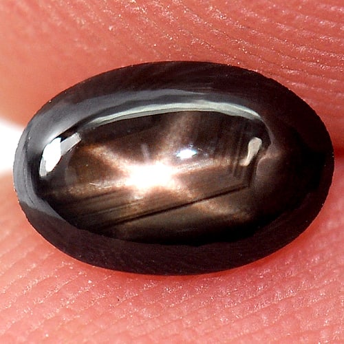 Natural Black Star Sapphire 0.81 Ct. Oval Cabochon Shape 6.7 x 4.5 Mm. Gemstone From Thailand: Product ID: 806144118 Product Name: Natural Star Sapphire Weight: 0.81 CT. Size: 6.7 x 4.5 x 2.5 MM. Shape: Oval Cabochon Color: Black Clarity:Opaque Luster: Good 6 Rays Star Gems Origin: Thailand Tre