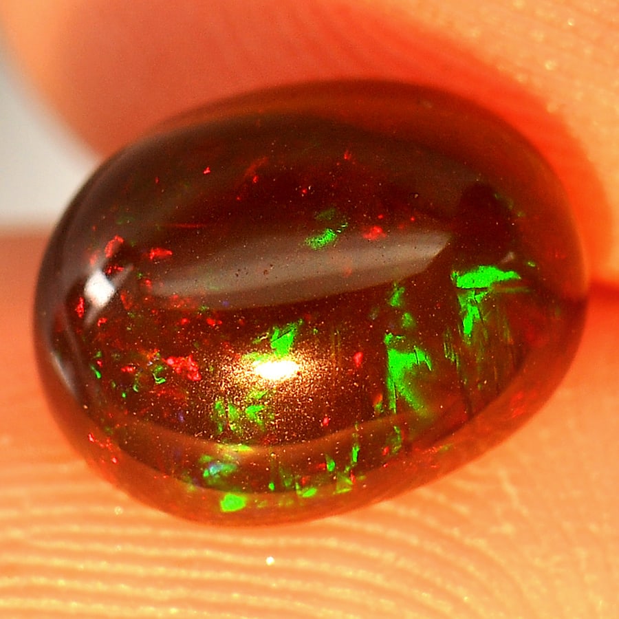 Natural Fire Red Black Opal 1.28 Ct. Oval Cabochon Shape 9 x 7 Mm Gemstone From Ethiopia: Product ID: 818725525 Product Name: Natural Opal Weight: 1.28 CT. Size: 9 x 7 x 4.1 MM. Shape: Oval Cabochon Color: Multi-Color Clarity:Opaque Luster: Iridescent Gems Origin: Ethiopia Treatment: Enhan