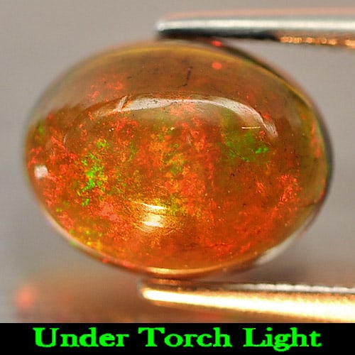 Natural Fire Red Black Opal 1.45 Ct. Oval Cabochon Shape 10 x 8 Mm. Gemstone: Product ID: 818724182 Product Name: Natural Opal Weight: 1.45 CT. Size: 10 x 8 x 4.3 MM. Shape: Oval Cabochon Color: Rainbow Fire Red Black Clarity:Semi - Transparent Luster: Iridescent Gems Origin: E