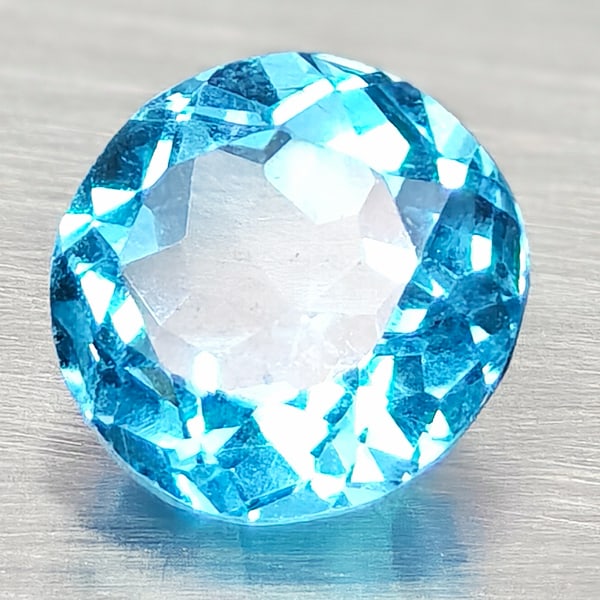 Natural Swiss Blue Topaz 1.33 Ct. Round Shape 6.4 Mm Gemstone From Brazil: Product ID: 807168109 Product Name: Natural Blue Topaz Weight: 1.33 CT. Size: 6.4 x 6.4 x 4.2 MM. Shape: Round Shape Color: Swiss Blue Clarity:VSI Luster: Good Gems Origin: Brazil Treatment: Treated C