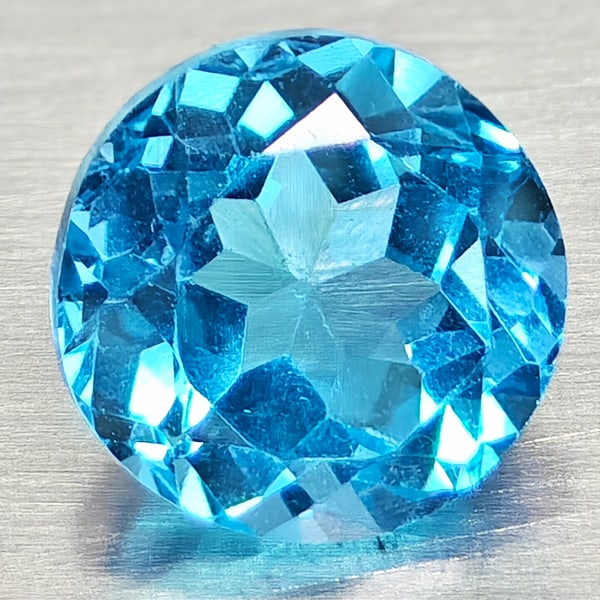 Natural Swiss Blue Topaz 1.92 Ct. Round Shape 7.1 Mm Gemstone From Brazil: Product ID: 807168116 Product Name: Natural Blue Topaz Weight: 1.92 CT. Size: 7.1 x 7.1 x 4.9 MM. Shape: Round Shape Color: Swiss Blue Clarity:VSI Luster: Good Gems Origin: Brazil Treatment: Treated C