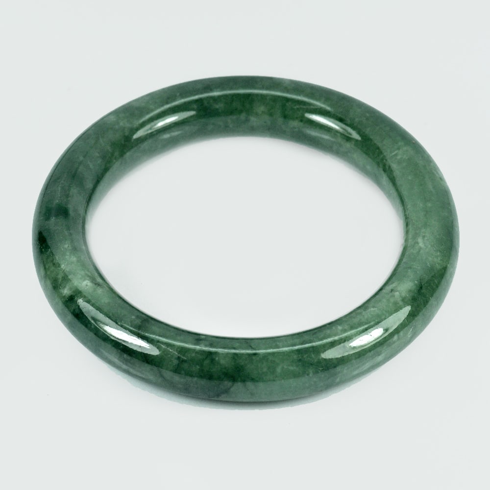 Natural Green Jade Bangle 368.82 Ct. Diameter 60 Mm. Unheated Gemstone: Product ID: 819814201 Product Name: Natural Jade Weight: 368.82 CT. Size: 80 x 60 x 12 MM. Shape: Round Cabochon Color: Green Clarity:Opaque Luster: Good Gems Origin: Thailand Treatment: Unheated Crys