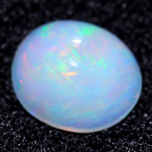 Natural Multi Color Opal 1.07 Ct. Oval Cabochon Shape 8.2 x 6.9 Mm. Unheated Gemstone: Product ID: 818713237 Product Name: Natural Opal Weight: 1.07 CT. Size: 8.2 x 6.9 x 4.3 MM. Shape: Oval Cabochon Color: Multi Color Clarity:Semi - Transparent Luster: Good Gems Origin: Ethiopia Treatm