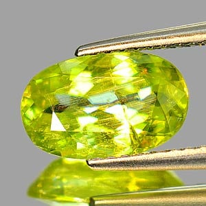 Natural Intense Yellowish Green Titanium Sphene 1.95 Ct. Oval Shape 10.2 x 6.4 Mm. Unheated Gemstone: Product ID: 806506054 Product Name: Natural Sphene Weight: 1.95 CT. Size: 10.2 x 6.4 x 4 MM. Shape: Oval Color: Intense Yellowish Green Titanium With Rainbow Clarity:SI Luster: Adamantine Gems Origin: