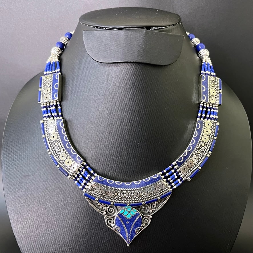 Turquoise & Afghani Lapis Handmade Boho Necklace: HANDMADE IN NEPAL M E T A L : Brass & Copper Mix Metal S T O N E : Natural Turquoise, Lapis & Coral S I Z E : 17-18 Inch Long W E I G H T : 100 Gram Approx Turquoise protects the wearer from negative 