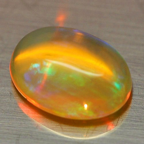 Natural Multi Color Opal 1.34 Ct. Oval Cabochon Shape 9.3 x 7 Mm. Unheated Gemstone: Product ID: 818726392 Product Name: Natural Opal Weight: 1.34 CT. Size: 9.3 x 7 x 4.4 MM. Shape: Oval Cabochon Color: Multi-Color Clarity:Semi - Transparent Luster: Iridescent Gems Origin: Ethiopia Tr