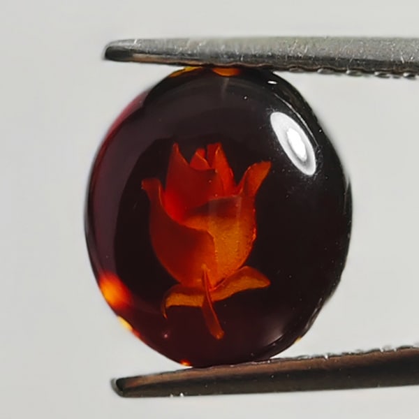 Natural Amber 0.48 Ct. Flower Carving In Oval Cabochon Shape 9 x 8 Mm. Gemstone From Poland: Product ID: 819090976 Product Name: Natural Amber Weight: 0.48 CT. Size: 8 x 9 x 2.5 MM. Shape: Oval Cabochon Color: Brown Yellow Clarity:Semi - Transparent Luster: Good Gems Origin: Poland Treatment: