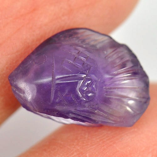 Purple Amethyst Fish Carving 4.71 Ct. Natural Gemstone Unheated: Product ID: 810303264 Product Name: Natural Amethyst Weight: 4.71 CT. Size: 14.7 x 9.8 x 6.5 MM. Shape: Fish Carving Color: Purple Clarity:Semi - Transparent Luster: Good Gems Origin: Brazil Treatment