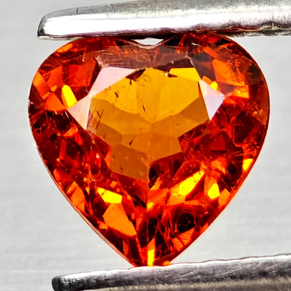 Natural Orangish Red Spessartine Garnet 0.96 Ct Heart Shape 6 x 5.9 Mm Gemstone From Namibia: Product ID: 802936818 Product Name: Natural Spessartine Weight: 0.96 CT. Size: 6 x 5.9 x 3.2 MM. Shape: Heart Shape Color: Orangish Red Clarity:VSI Luster: Good Gems Origin: Namibia,Africa Treatment: 