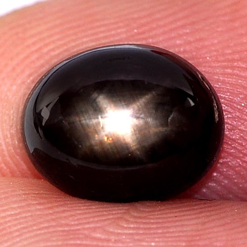 Natural Black Star Sapphire 6 Rays 4.33 Ct. Oval Cabochon Shape 9.5 x 7.6 Mm Gemstone From Thailand: Product ID: 806134464 Product Name: Natural Star Sapphire Weight: 4.33 CT. Size: 9.5 x 7.6 x 5.3 MM. Shape: Oval Cabochon Color: Black Clarity:Opaque Luster: Good 6 Rays Star Gems Origin: Thailand Tre