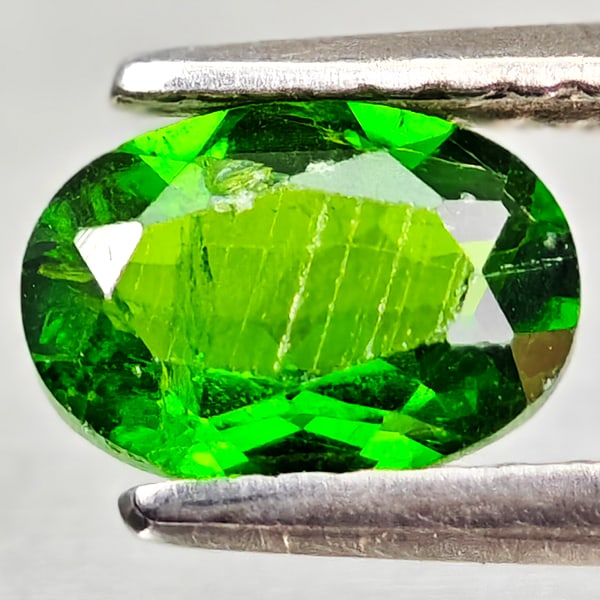 Natural Green Chrome Diopside 0.78 Ct. Oval Shape 7 x 5 Mm Gemstone From Russia: Product ID: 801608147 Product Name: Natural Chrome Diopside Weight: 0.78 CT. Size: 7 x 5 x 2.9 MM. Shape: Oval Color: Green Clarity:VSI - SI1 Luster: Good Gems Origin: Russia Treatment: Unheated Cryst