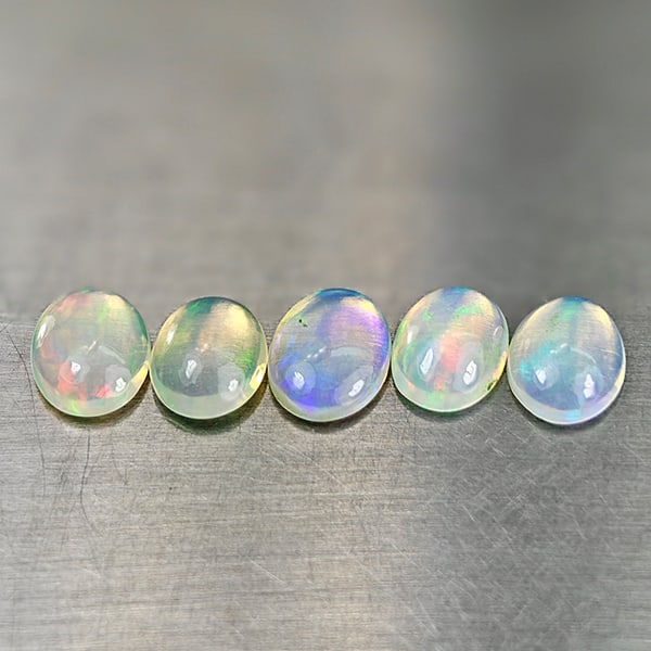 Natural Multi-Color Opal 2.84 Ct. 5 Pcs Oval Cabochon Shape 8 x 6.2 Mm. Unheated Gemstones: Product ID: 818728040 Product Name: Natural Opal Weight: 2.84 CT. Size: 8 x 6.2 x 2.7 MM. Shape: Oval Cabochon Color: Multi-Color Clarity:Semi - Transparent Luster: Good Gems Origin: Ethiopia Treatmen