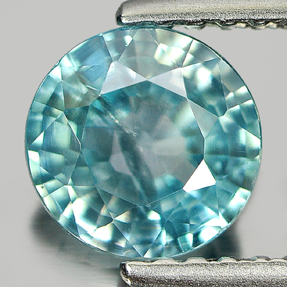 Natural Blue Zircon 1.26 Ct. Round Shape 6.4 Mm. Gemstone From Cambodia: Product ID: 807714316 Product Name: Natural Zircon Weight: 1.26 CT. Size: 6.4 x 6.4 x 3.1 MM. Shape: Round Color: Blue Clarity:SI1 Luster: Good Gems Origin: Cambodia Treatment: Heated Crystal Structur