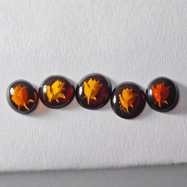 Natural Amber 3.01 Ct. 5 Pcs. Flower Carving In Oval Cabochon Shape 9.2 x 8.2 Mm Gemstone: Product ID: 819091019 Product Name: Natural Amber Weight: 2.65 CT. Size: 9.2 x 8.2 x 2.7 MM. Shape: Oval Cabochon Color: Brown Yellow Clarity:Semi - Transparent Luster: Good Gems Origin: Poland Treatm