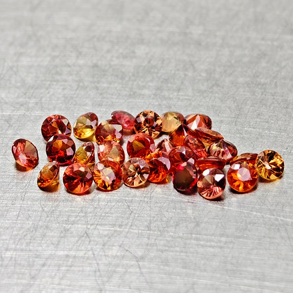 Natural Orange Red Songea Sapphire 2.31 Ct. 29 Pcs. Round Diamond Cut 2.6 Mm. Gemstones From: Product ID: 806162042 Product Name: Natural Red Sapphire Weight: 2.31 CT. Size: 2.6 x 2.6 x 1.6 MM. Shape: Round Diamond Cut Color: Red Orange Clarity:VSI Luster: Good Gems Origin: Tanzania Treatment: