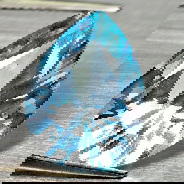 Natural Swiss Blue Topaz 9.58 Ct. Pear Shape 16 x 11.8 Mm Gemstone From Brazil: Product ID: 807168007 Product Name: Natural Blue Topaz Weight: 9.58 CT. Size: 16.2 x 12.2 x 7.7 MM. Shape: Pear Shape Color: Swiss Blue Clarity:VSI - SI1 Luster: Good Gems Origin: Brazil Treatment: Tr