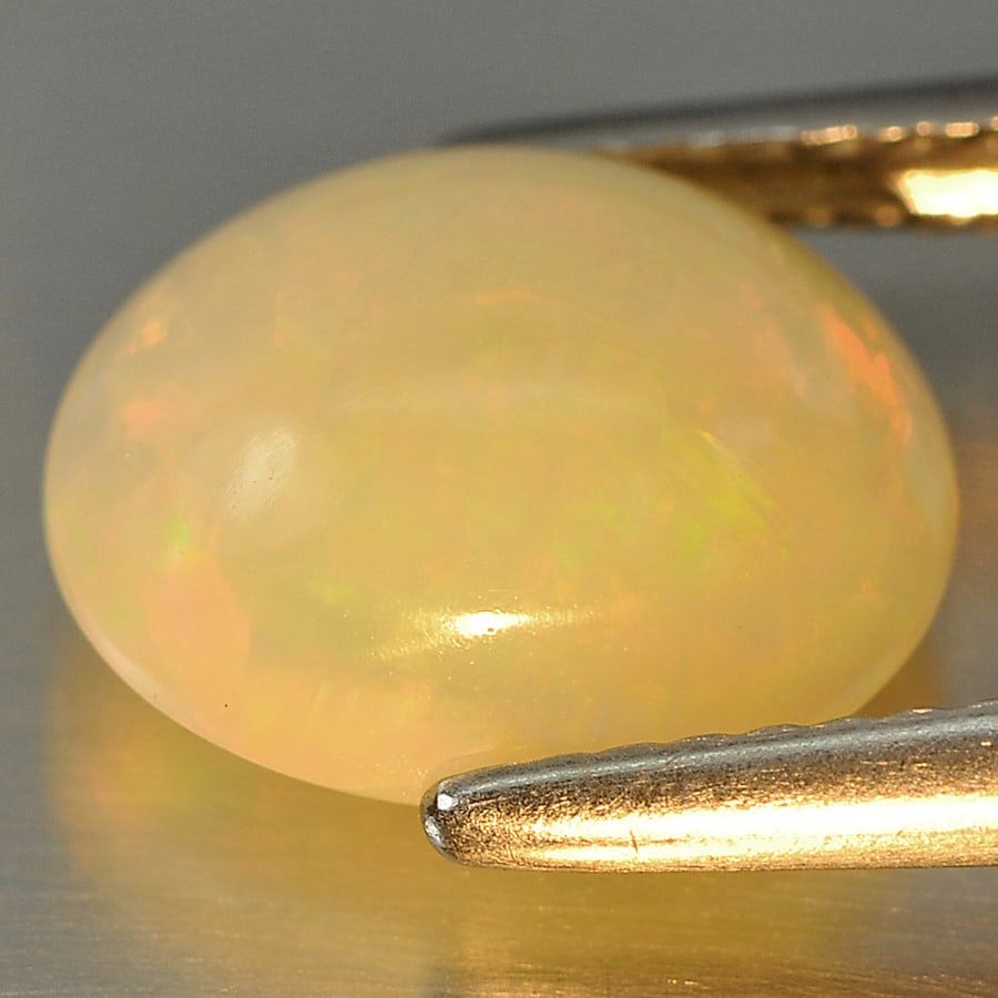 Natural Multi Color Opal 2.28 Ct. Oval Cabochon Shape 10.7 x 8.8 Mm Gemstone From Ethiopia: Product ID: 818708496 Product Name: Natural Opal Weight: 2.28 CT. Size: 10.7 x 8.8 x 5 MM. Shape: Oval Cabochon Color: Multi Color Clarity:Semi - Transparent Luster: Good Gems Origin: Ethiopia Treatme