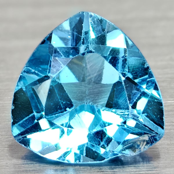 Natural Swiss Blue Topaz 2.57 Ct. Trilliant Shape 9 Mm Gemstone From Brazil: Product ID: 807167951 Product Name: Natural Blue Topaz Weight: 2.57 CT. Size: 9 x 9 x 4.9 MM. Shape: Trilliant Color: Swiss Blue Clarity:VSI Luster: Good Gems Origin: Brazil Treatment: Treated Crystal
