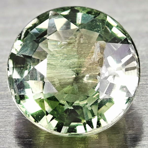 Natural Green Sapphire 0.74 Ct. Round Shape 5 Mm Gemstone from Thailand: Product ID: 106114277 Product Name: Natural Green Sapphire Weight: 0.74 CT. Size: 5 x 5 x 3 MM. Shape: Round Color: Greem Clarity:VSI Luster: Good Gems Origin: Thailand Treatment: Warm Crystal Structu