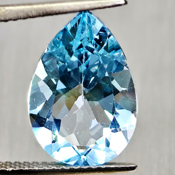 Natural Swiss Blue Topaz 6.83 Ct. Pear Shape 15.2 x 10.4 Mm Gemstone From Brazil: Product ID: 807167903 Product Name: Natural Blue Topaz Weight: 6.83 CT. Size: 15.2 x 10.4 x 6.8 MM. Shape: Pear Shape Color: Swiss Blue Clarity:VSI Luster: Good Gems Origin: Brazil Treatment: Treated