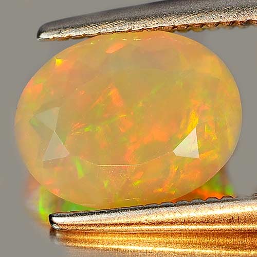 Natural Multi Color Opal 0.96 Ct. Oval Shape 9.1 x 7.2 Mm. Unheated Gemstone: Product ID: 818725896 Product Name: Natural Opal Weight: 0.96 CT. Size: 9.1 x 7.2 x 3.8 MM. Shape: Oval Color: Multi Color Clarity:Semi - Transparent Luster: Strong Iridescent Gems Origin: Ethiopia Tr