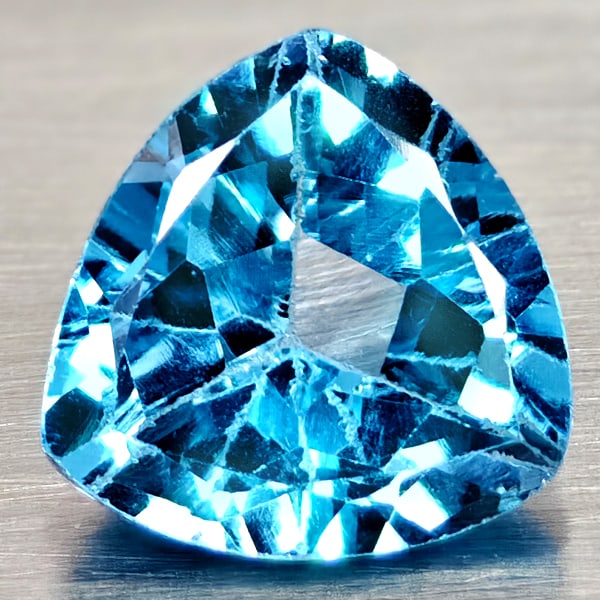 Natural Swiss Blue Topaz 3.31 Ct. Trilliant Shape 9.1 Mm Gemstones From Brazil: Product ID: 807167970 Product Name: Natural Blue Topaz Weight: 3.31 CT. Size: 9.1 x 9.1 x 5.6 MM. Shape: Trilliant Color: Swiss Blue Clarity:VSI Luster: Good Gems Origin: Brazil Treatment: Treated Cry