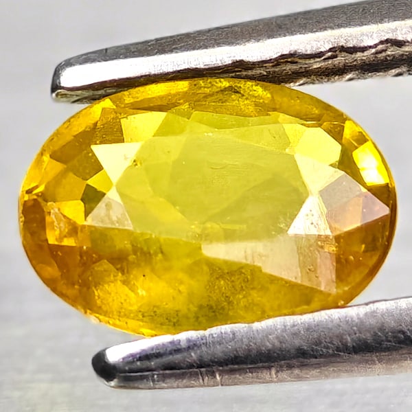 Natural Yellow Sapphire 0.78 Ct. Oval Shape 6.5 x 4.8 Mm. Gemstone From Thailand: Product ID: 806162555 Product Name: Natural Yellow Sapphire Weight: 0.78 CT. Size: 6.5 x 4.8 x 2.5 MM. Shape: Oval Color: Yellow Clarity:VSI - SI1 Luster: Good Gems Origin: Thailand Treatment: Heated 