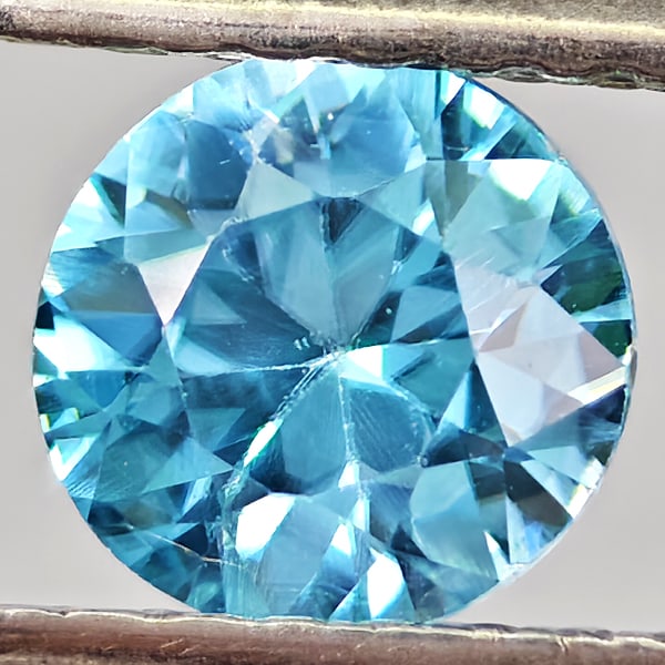 Natural Blue Zircon 0.73 Ct. Round Shape 5.4 Mm Gemstone From Cambodia: Product ID: 807743054 Product Name: Natural Zircon Weight: 0.73 CT. Size: 5.4 x 5.4 x 3.1 MM. Shape: Round Color: Blue Clarity:VSI - SI1 Luster: Good Gems Origin: Cambodia Treatment: Heated Crystal St