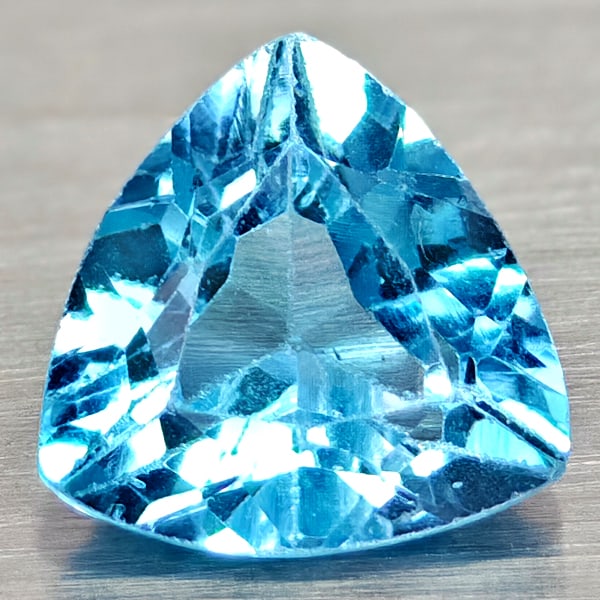 Natural Swiss Blue Topaz 2.96 Ct. Trilliant Shape 9 Mm. Gemstone From Brazil: Product ID: 807167953 Product Name: Natural Blue Topaz Weight: 2.96 CT. Size: 9 x 9 x 5.4 MM. Shape: Trilliant Color: Swiss Blue Clarity:VSI Luster: Good Gems Origin: Brazil Treatment: Treated Crystal