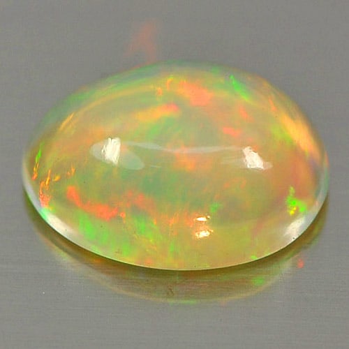Natural Multi Color Play Of Colour Opal 0.76 Ct. Oval Cabochon Shape 7.9 x 6 Mm Gemstone From: Product ID: 818726327 Product Name: Natural Opal Weight: 0.76 CT. Size: 7.9 x 6 x 3.4 MM. Shape: Oval Cabochon Color: Multi Color Clarity:Semi - Transparent Luster: Iridescent Gems Origin: Ethiopia Tr