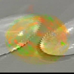 Natural Multi Color Play Of Colour Opal 0.76 Ct. Oval Cabochon Shape 7.9 x 6 Mm Gemstone From: Product ID: 818726327 Product Name: Natural Opal Weight: 0.76 CT. Size: 7.9 x 6 x 3.4 MM. Shape: Oval Cabochon Color: Multi Color Clarity:Semi - Transparent Luster: Iridescent Gems Origin: Ethiopia Tr