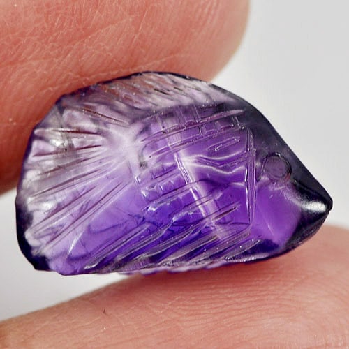 Natural Violet Amethyst 5.70 Ct. Fish Carving Shape 16.6 x 10.5 Mm Gemstone From Brazil: Product ID: 810303410 Product Name: Natural Amethyst Weight: 5.70 CT. Size: 16.6 x 10.5 x 5.8 MM. Shape: Fish Carving Color: Violet Clarity:Semi - Transparent Luster: Good Gems Origin: Brazil Treatmen