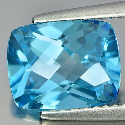 Natural Swiss Blue 3.42 Ct. Clean Cushion Checkerboard Cut 9.9 x 7.8 Mm. Gemstone From Brazil: Product ID: 807166048 Product Name: Natural Blue Topaz Weight: 3.42 CT. Size: 9.9 x 7.8 x 5.2 MM. Shape: Cushion Checkerboard Color: Blue Clarity:IF Luster: Good Gems Origin: Brazil Treatment: Treated
