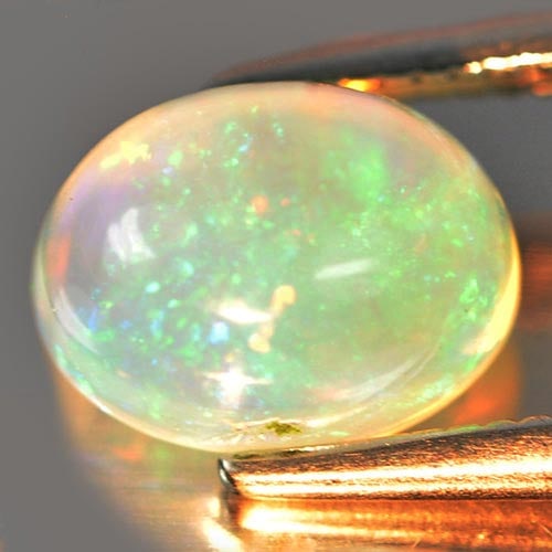 Natural Multi Color Opal 1.21 Ct. Oval Cabochon Shape 8.1 x 6 Mm. Unheated Gemstone: Product ID: 818725874 Product Name: Natural Opal Weight: 1.21 CT. Size: 8.1 x 6 x 4.8 MM. Shape: Oval Cabochon Color: Multi Color Clarity:Semi - Transparent Luster: Strong Iridescent Gems Origin: Ethi